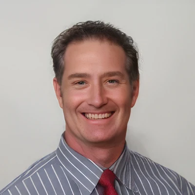 Jeff Cook smiling for a professional portrait at Cook Chiropractic.