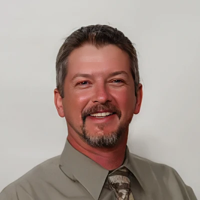 Randal Troutman smiling for a professional portrait at Cook Chiropractic.