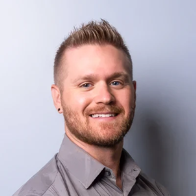 Zach Cook smiling for a professional portrait at Cook Chiropractic.