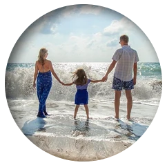 family walking together on the beach
